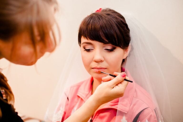Bride having her hair and makeup prepared by salon professionals