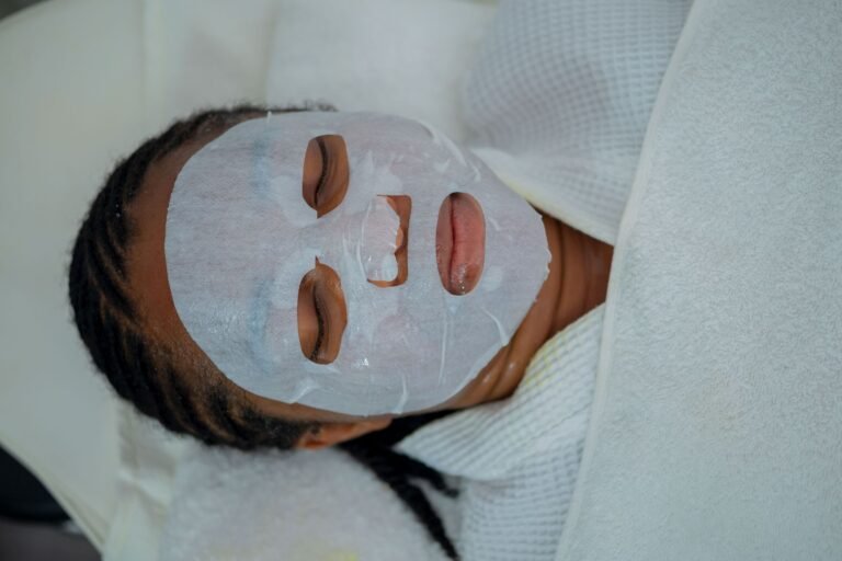 Client receiving a cleansing facial mask treatment at a spa