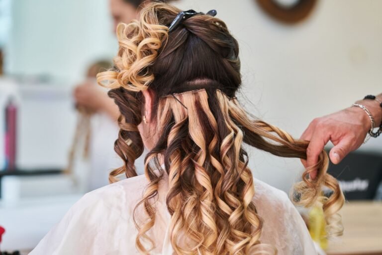 Stylist creating an elegant event hairstyle in a salon
