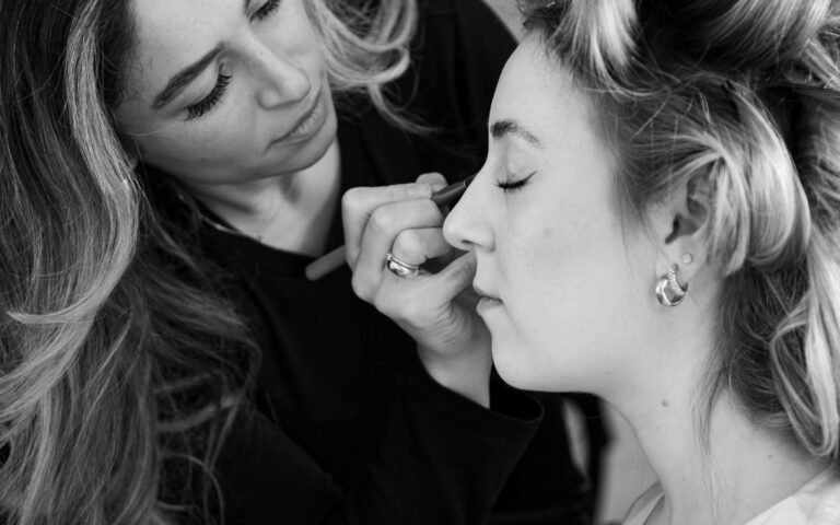 Makeup artist applying cosmetics to a client in a salon