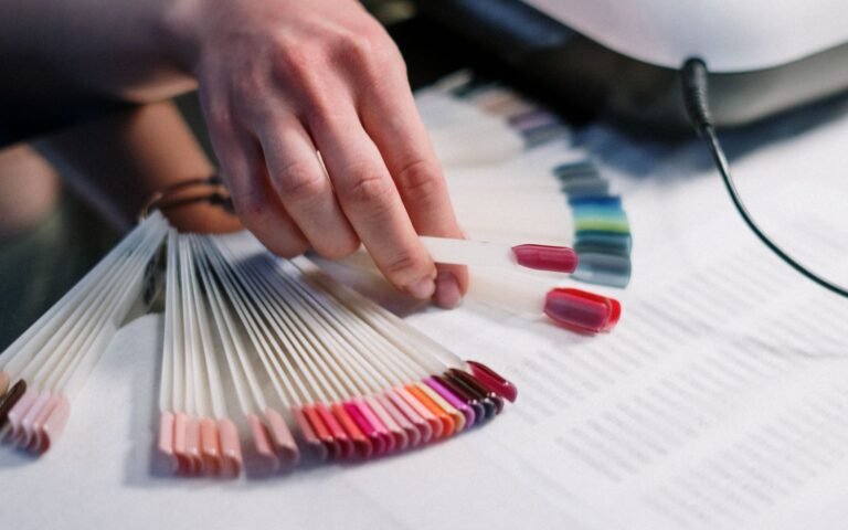 Manicurist selecting nail polish colors in a salon setting
